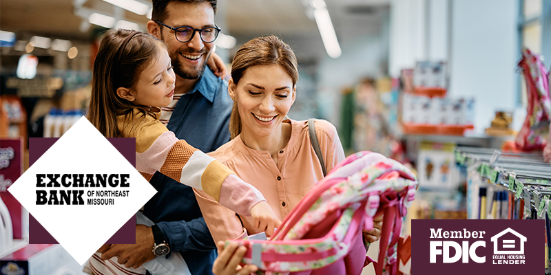 Mom and dad with daughter looking at supplies in the store